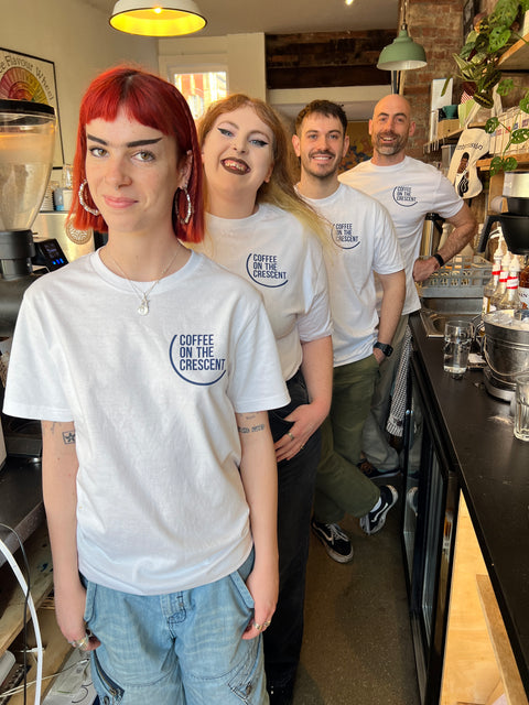 The COTC baristas in a line all wearing COTC tee shirts